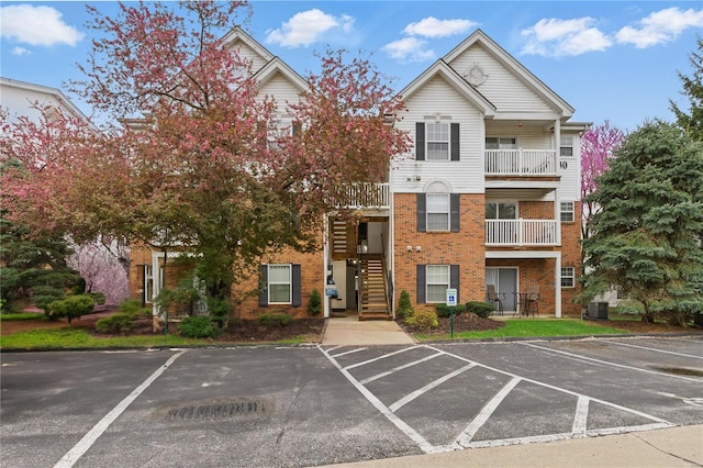 430 Benton Dr Unit C, Saint Peters, MO 63376 - view of building exterior featuring uncovered parking, stairway, and central AC unit