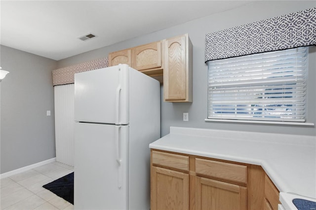 430 Benton Dr Unit C, Saint Peters, MO 63376 - kitchen with freestanding refrigerator, light brown cabinets, light countertops, and light tile patterned floors