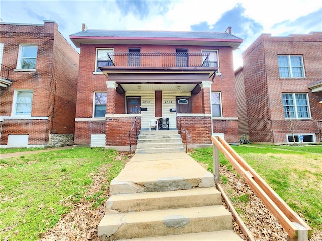 4052 Detonty St, Saint Louis, MO 63110 - view of front of home featuring a balcony, a porch, brick siding, and a front yard