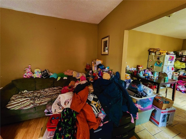 4052 Detonty St, Saint Louis, MO 63110 - bedroom with a textured ceiling and freestanding refrigerator