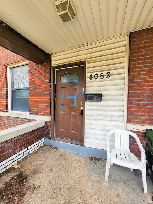 4052 Detonty St, Saint Louis, MO 63110 - view of exterior entry with brick siding and a porch