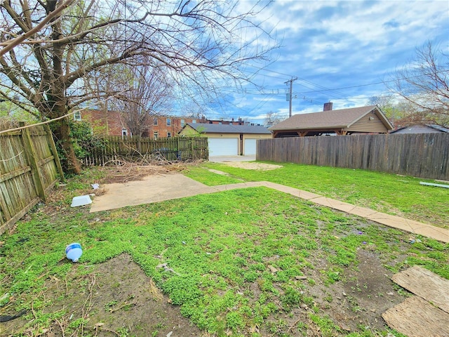 4052 Detonty St, Saint Louis, MO 63110 - view of yard featuring a patio, an outdoor structure, and a garage