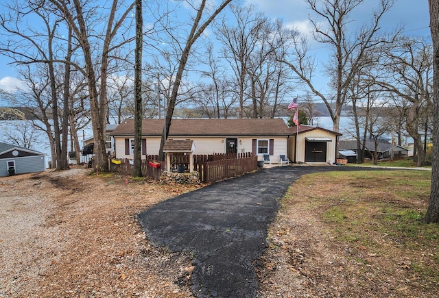 15 Allen Cir, Sunrise Beach, MO 65079 - ranch-style house featuring an outbuilding, fence, asphalt driveway, and a chimney
