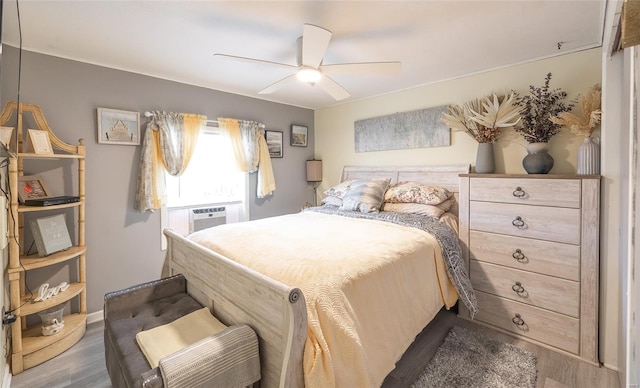 15 Allen Cir, Sunrise Beach, MO 65079 - bedroom with wood finished floors, a ceiling fan, and cooling unit
