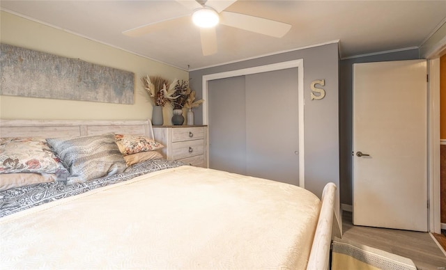 15 Allen Cir, Sunrise Beach, MO 65079 - bedroom with crown molding, wood finished floors, a closet, and a ceiling fan