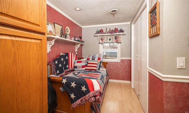 15 Allen Cir, Sunrise Beach, MO 65079 - bedroom featuring light wood-style floors, ornamental molding, and a textured ceiling