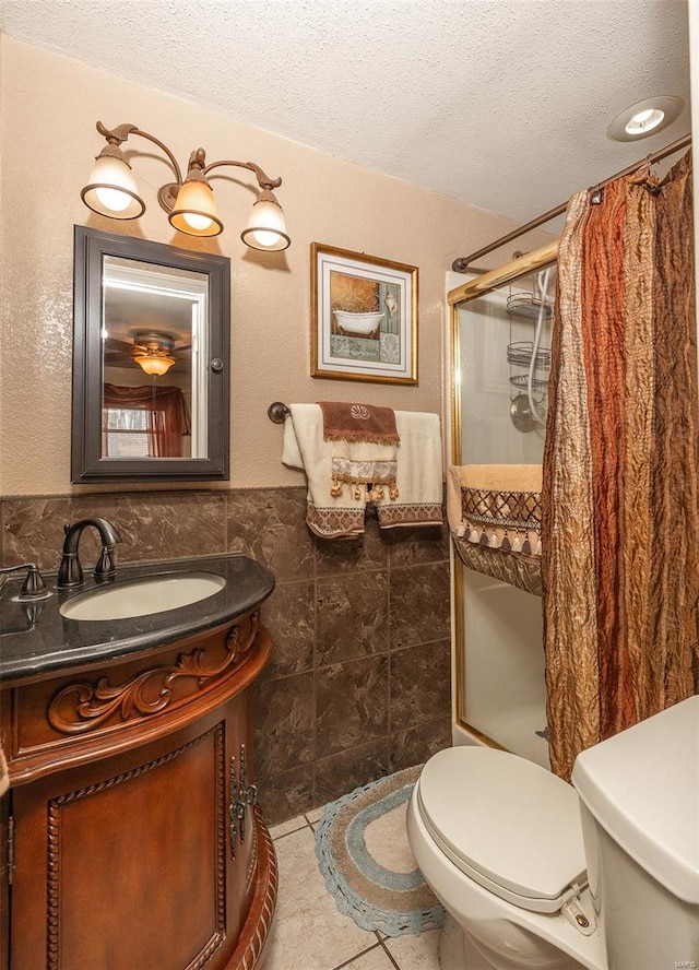 15 Allen Cir, Sunrise Beach, MO 65079 - bathroom with tile walls, a textured ceiling, a stall shower, toilet, and vanity