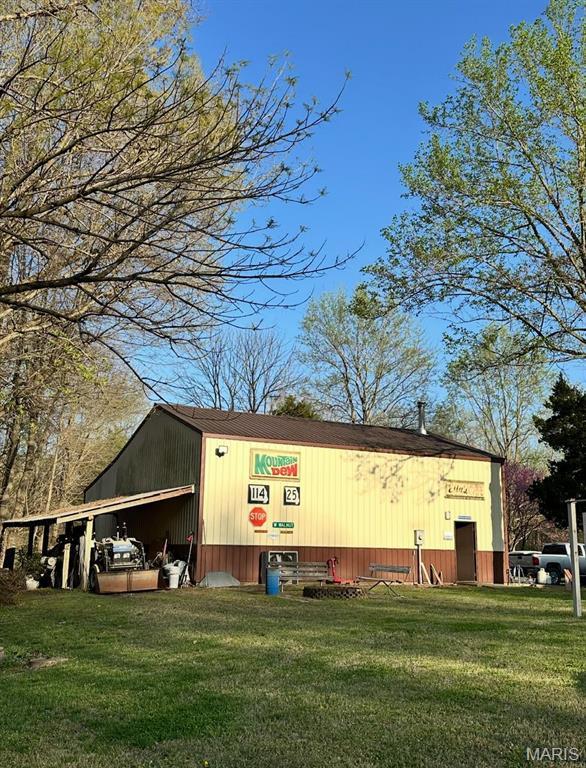 view of pole building with a lawn