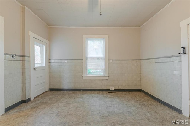 338 Horn Ave, Saint Louis, MO 63125 - unfurnished room with tile walls, ornamental molding, a wainscoted wall, and tile patterned floors