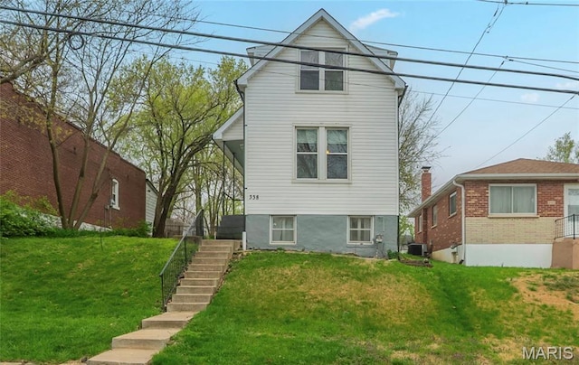 338 Horn Ave, Saint Louis, MO 63125 - view of front of property with stairway, a front lawn, and central air condition unit