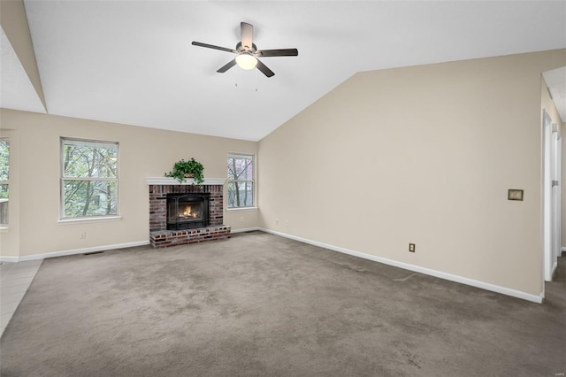 413 Oak Pl, Lake St Louis, MO 63367 - unfurnished living room with ceiling fan, baseboards, vaulted ceiling, a brick fireplace, and carpet floors
