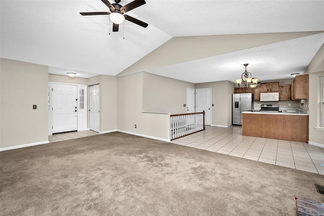413 Oak Pl, Lake St Louis, MO 63367 - unfurnished living room with light tile patterned floors, a chandelier, lofted ceiling, light carpet, and baseboards
