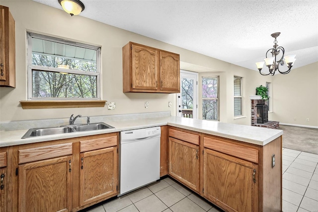 413 Oak Pl, Lake St Louis, MO 63367 - kitchen with white dishwasher, a sink, a peninsula, light tile patterned flooring, and light countertops