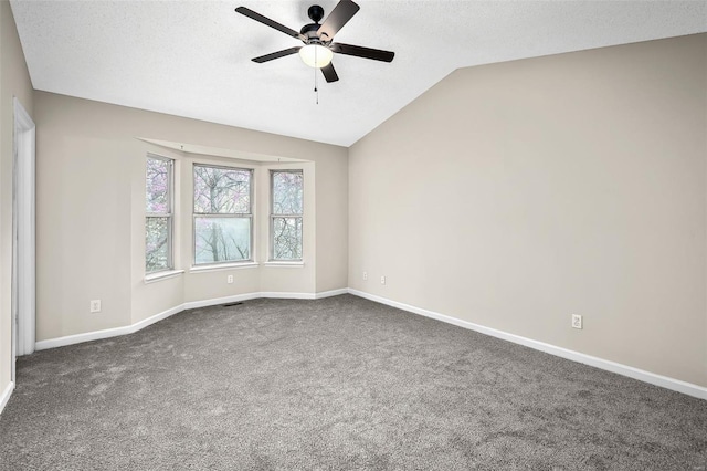 413 Oak Pl, Lake St Louis, MO 63367 - unfurnished room with ceiling fan, dark carpet, vaulted ceiling, baseboards, and a textured ceiling