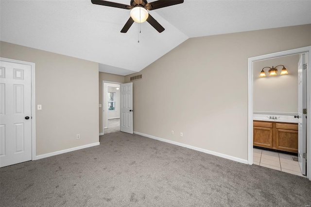 413 Oak Pl, Lake St Louis, MO 63367 - unfurnished bedroom with light carpet, lofted ceiling, a sink, connected bathroom, and baseboards