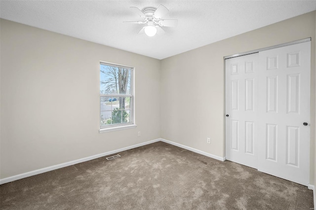 413 Oak Pl, Lake St Louis, MO 63367 - unfurnished bedroom featuring carpet, baseboards, a closet, a ceiling fan, and a textured ceiling