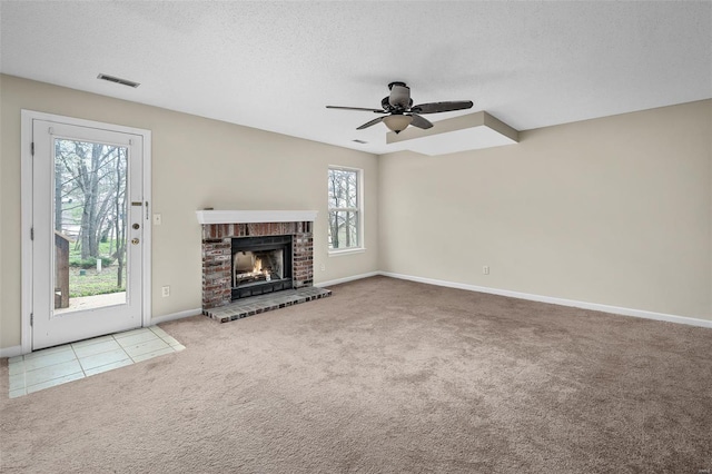 413 Oak Pl, Lake St Louis, MO 63367 - unfurnished living room featuring carpet flooring, plenty of natural light, a ceiling fan, baseboards, and a textured ceiling