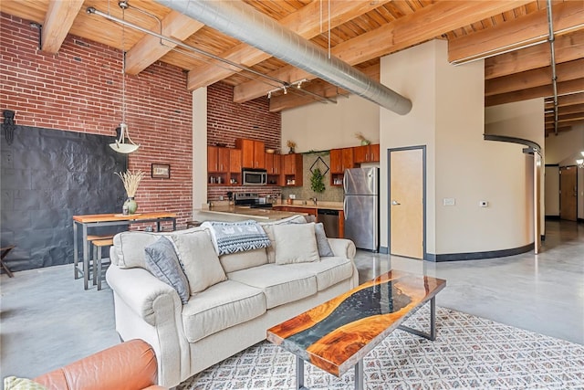 living area with wooden ceiling, concrete floors, a high ceiling, brick wall, and beam ceiling