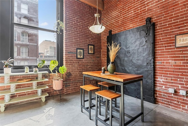 bar with concrete flooring and brick wall