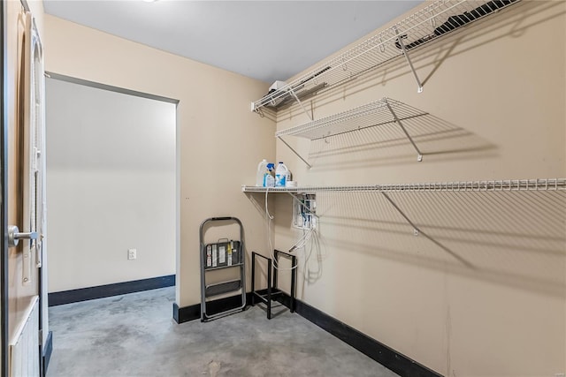 clothes washing area featuring baseboards