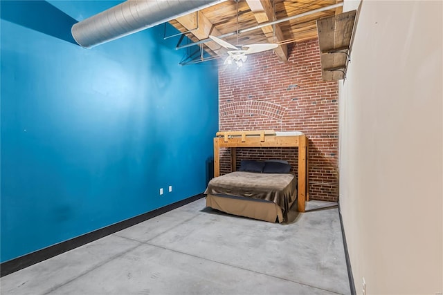 bedroom with brick wall and concrete flooring