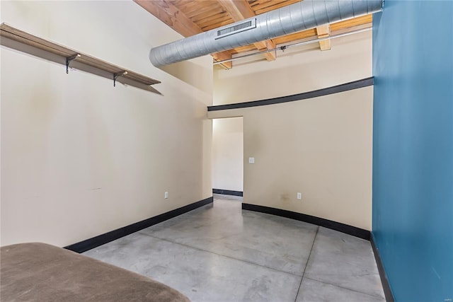 spare room with finished concrete flooring and baseboards