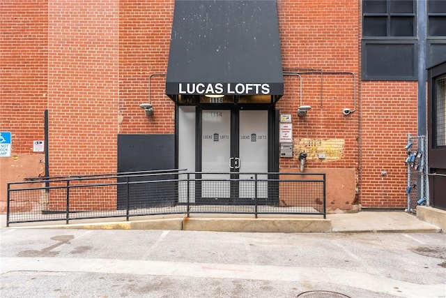 entrance to property featuring brick siding