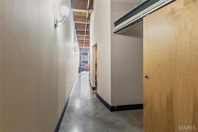 1123 Washington Ave Unit 305, Saint Louis, MO 63101 - hallway featuring baseboards and concrete floors