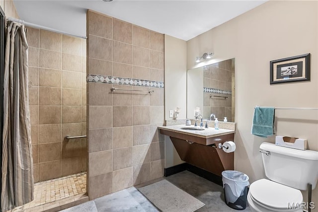 1123 Washington Ave Unit 305, Saint Louis, MO 63101 - bathroom featuring a tile shower, toilet, and vanity