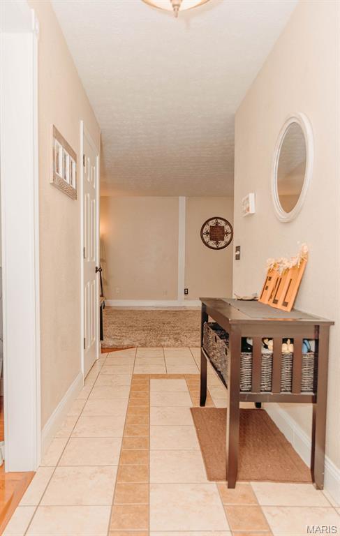 17145 Lensman Rd, Saint Robert, MO 65584 - hall with light tile patterned floors and baseboards