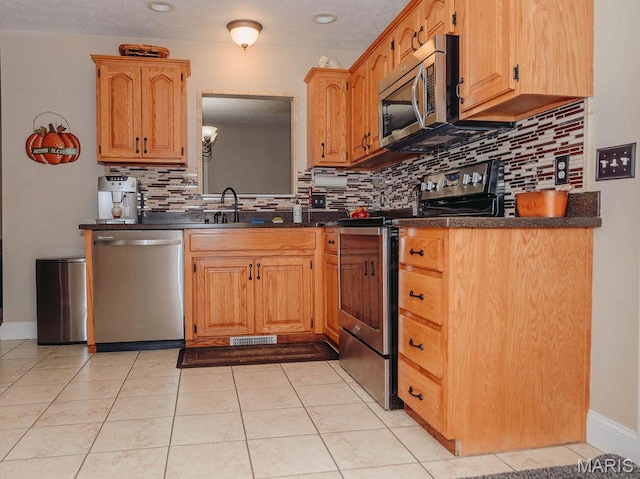 17145 Lensman Rd, Saint Robert, MO 65584 - kitchen featuring appliances with stainless steel finishes, dark countertops, backsplash, and a sink