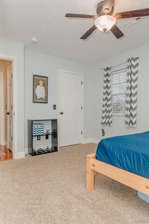 17145 Lensman Rd, Saint Robert, MO 65584 - bedroom featuring carpet floors, baseboards, and ceiling fan