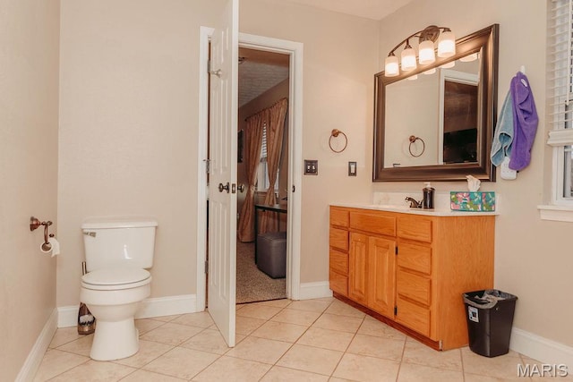 17145 Lensman Rd, Saint Robert, MO 65584 - bathroom featuring toilet, vanity, tile patterned floors, and baseboards