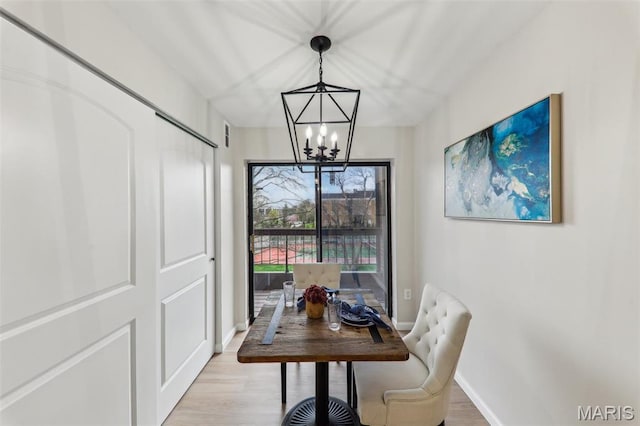 539 Coeur De Royale Dr Unit 201, Saint Louis, MO 63141 - dining space featuring a chandelier, baseboards, and light wood-type flooring
