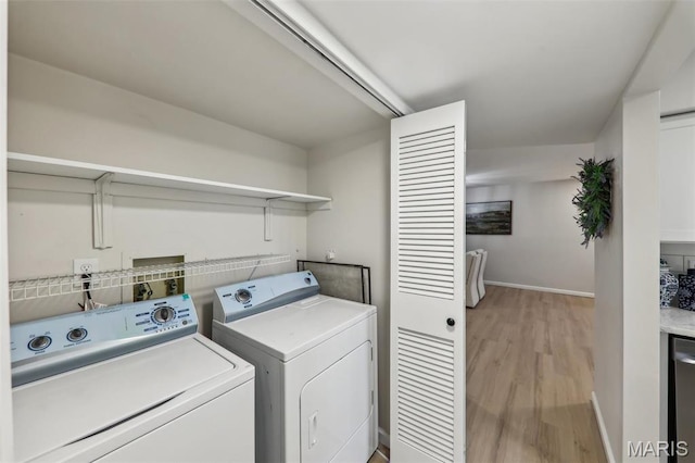 539 Coeur De Royale Dr Unit 201, Saint Louis, MO 63141 - laundry area featuring washing machine and clothes dryer, light wood-style floors, and baseboards