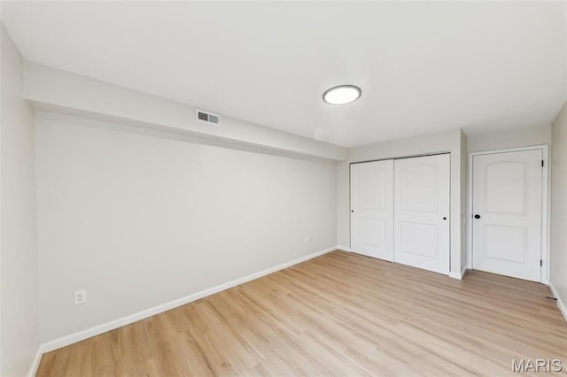 539 Coeur De Royale Dr Unit 201, Saint Louis, MO 63141 - unfurnished bedroom featuring baseboards, light wood-style flooring, and a closet