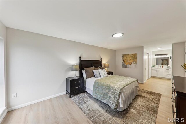 539 Coeur De Royale Dr Unit 201, Saint Louis, MO 63141 - bedroom featuring light wood-style floors, baseboards, and ensuite bath