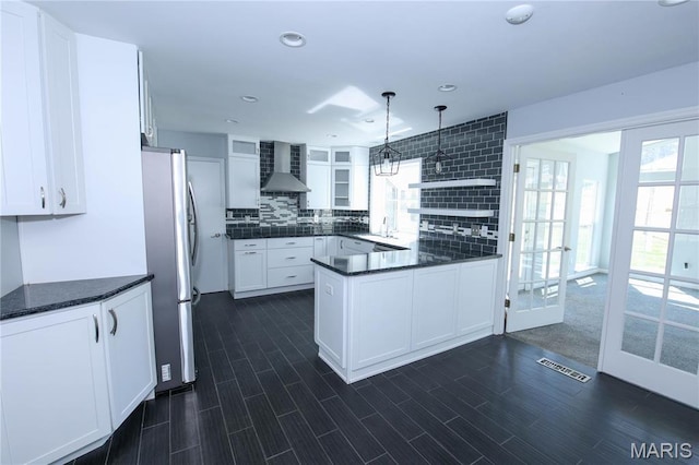 12530 Trammell Ct, Creve Coeur, MO 63141 - kitchen with wall chimney range hood, freestanding refrigerator, a sink, healthy amount of natural light, and recessed lighting
