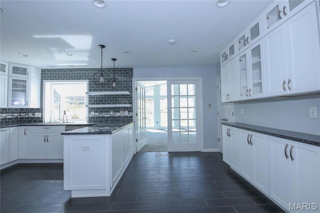 12530 Trammell Ct, Creve Coeur, MO 63141 - kitchen featuring white cabinets, decorative backsplash, glass insert cabinets, decorative light fixtures, and recessed lighting