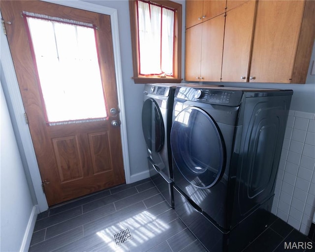 12530 Trammell Ct, Creve Coeur, MO 63141 - laundry room with separate washer and dryer, cabinet space, baseboards, and dark tile patterned floors