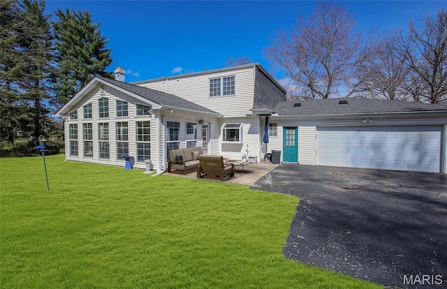 12530 Trammell Ct, Creve Coeur, MO 63141 - back of property featuring a chimney, an outdoor hangout area, asphalt driveway, a yard, and a garage