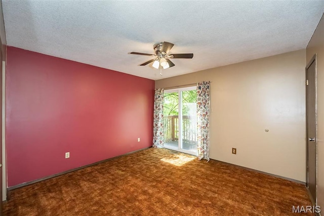 carpeted empty room with ceiling fan and a textured ceiling