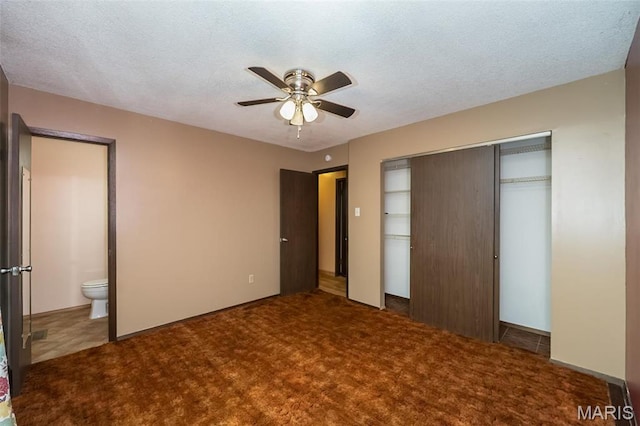 unfurnished bedroom featuring carpet floors, a textured ceiling, a closet, connected bathroom, and a ceiling fan