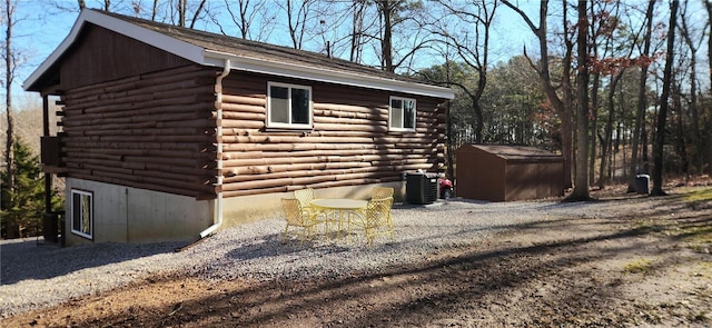 13559 Kitt Park Dr, Saint Genevieve, MO 63670 - view of side of property with log exterior, a storage shed, an outbuilding, and cooling unit