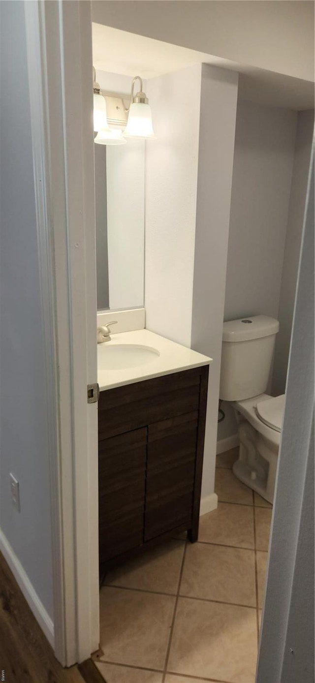 13559 Kitt Park Dr, Saint Genevieve, MO 63670 - bathroom featuring toilet, vanity, tile patterned flooring, and baseboards