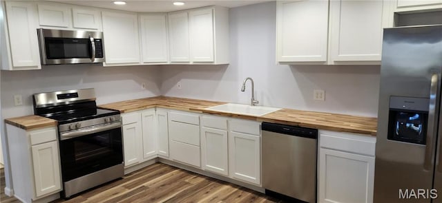 13559 Kitt Park Dr, Saint Genevieve, MO 63670 - kitchen featuring stainless steel appliances, butcher block countertops, recessed lighting, white cabinetry, and light wood-style flooring