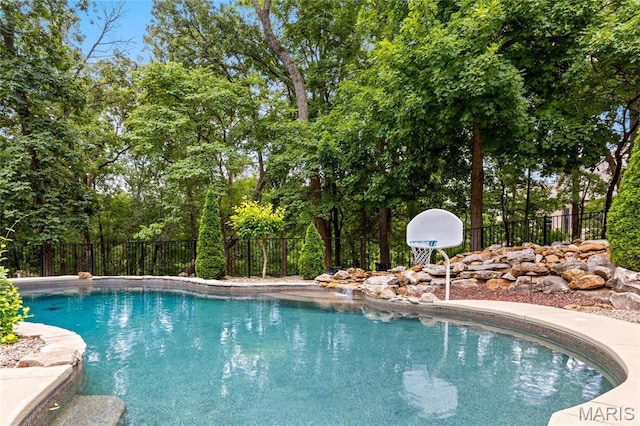 view of swimming pool with fence