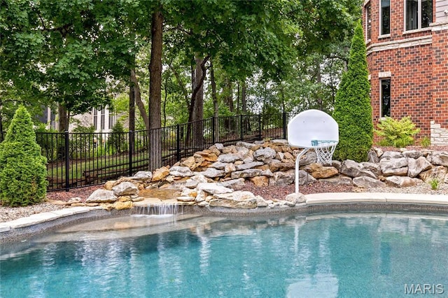 view of swimming pool with fence