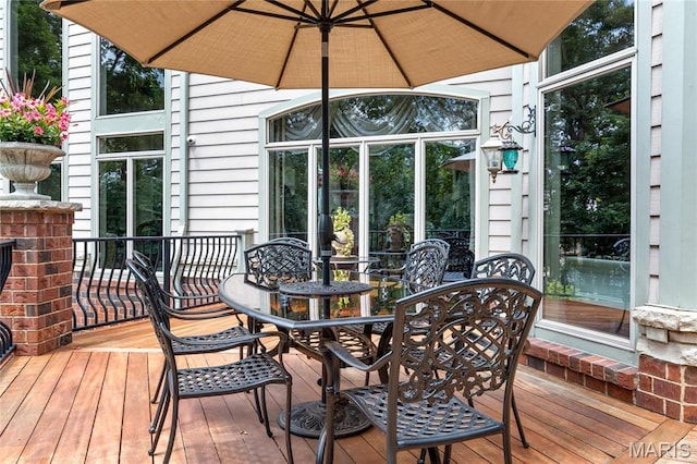 wooden deck featuring outdoor dining space