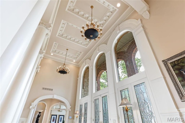 detailed view of crown molding and a chandelier